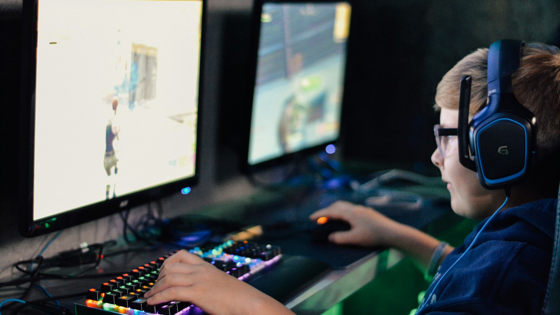 Players competing at illuminated battlestations in the EpicWildFrontier studio